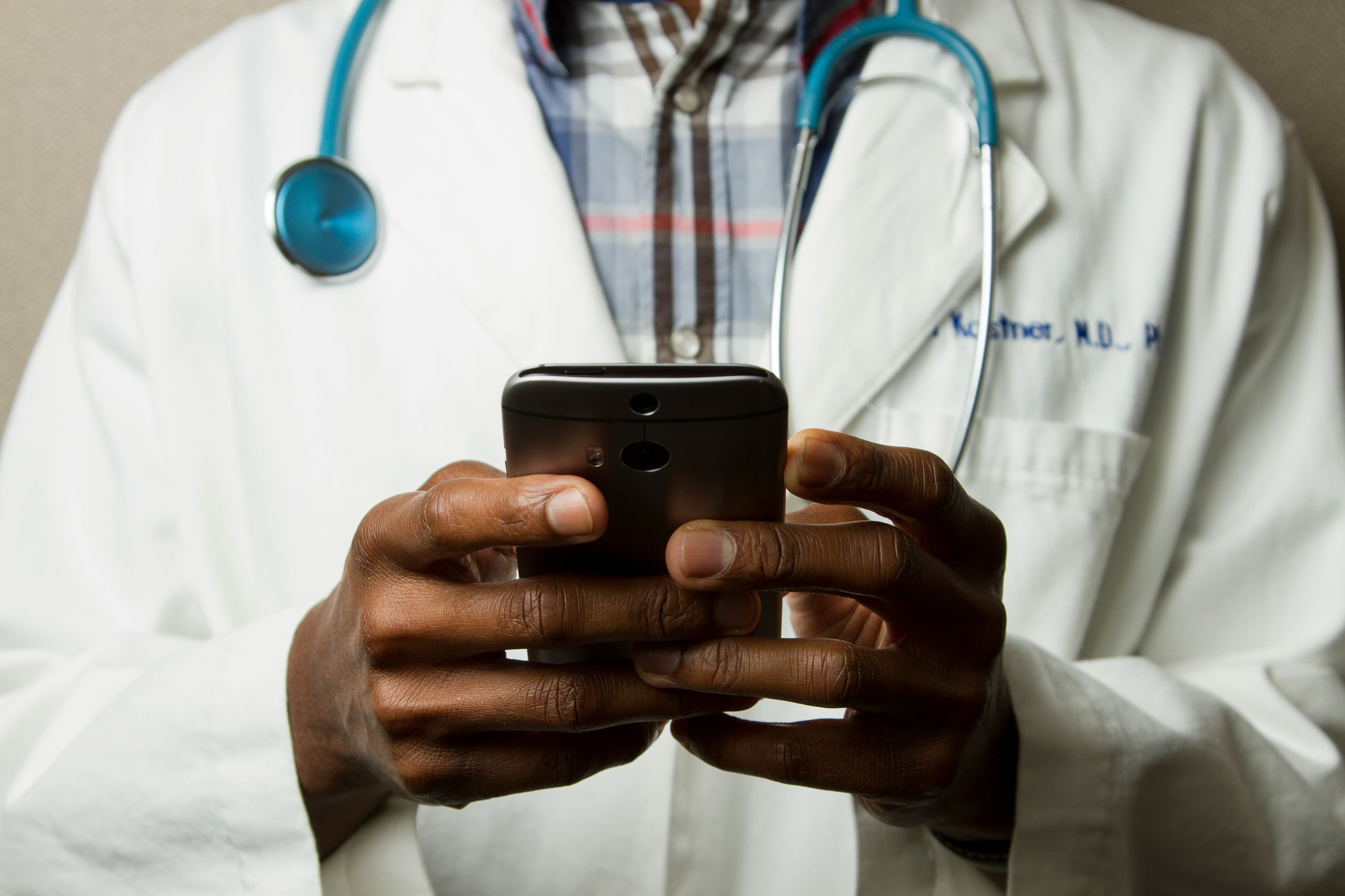 A clinician reviewing patient data on a smartphone