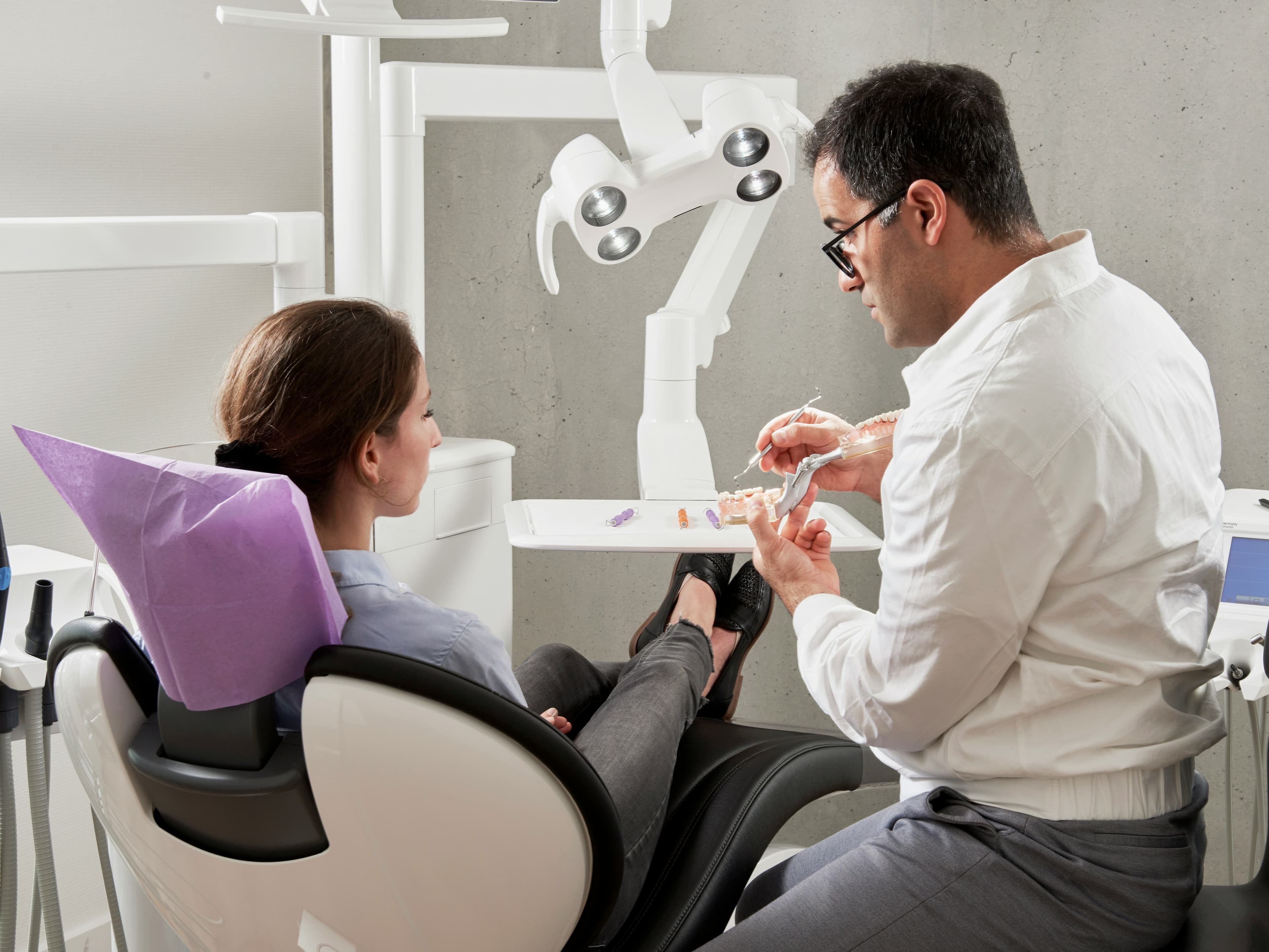 A dentist consulting with a patient in a clinic